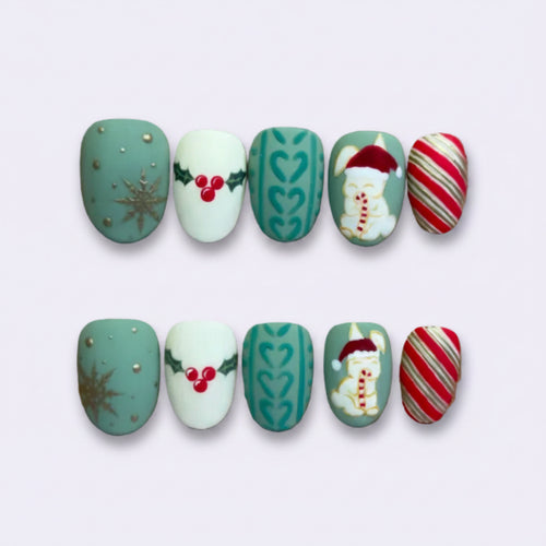 A set of 10 Christmas-themed press-on nails displayed on a brown cardboard backing against a light purple background. The designs include teal with gold glitter, white with red berries, teal with green hearts, a Santa Claus design, and red-and-white candy canes.