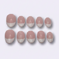Ten oval nail tips in a dusty pink and white color-blocked design, arranged in two rows of five on a light gray background.