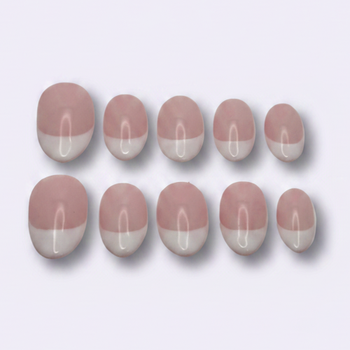 Ten oval nail tips in a dusty pink and white color-blocked design, arranged in two rows of five on a light gray background.